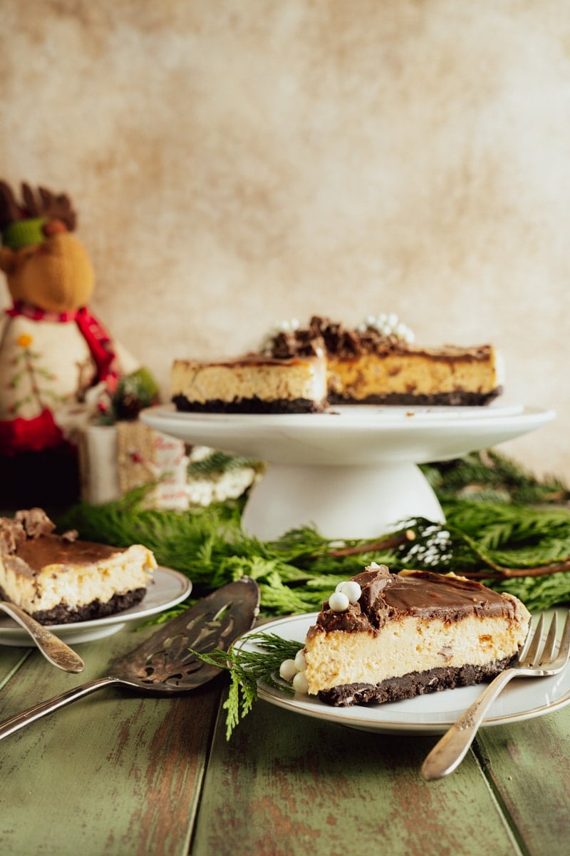 A Philadelphia cream cheese no-bake cheesecake with two slices cut out on a winter table.