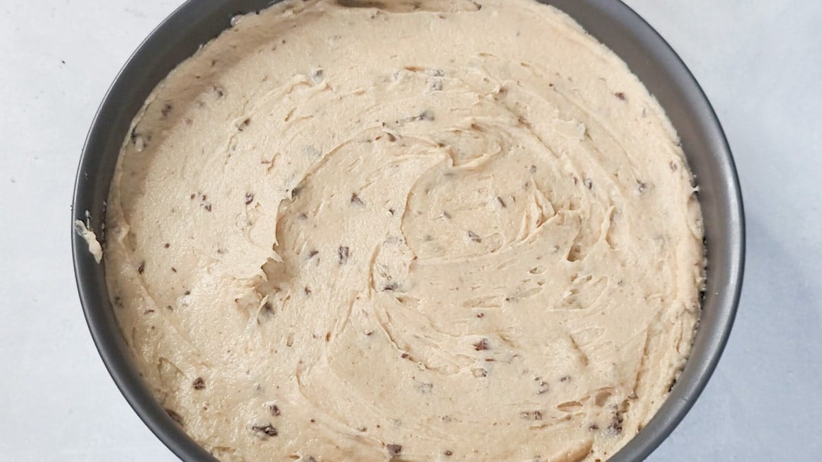 Chocolate peanut butter cheesecake filling in a springform pan.