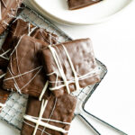 Chocolate vegan no bake cookies on a wire tray.