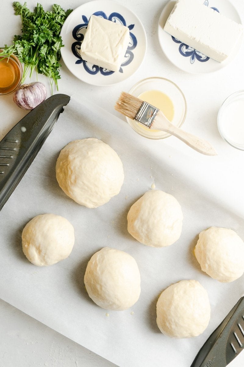 Bread rolls on a sheet washed with egg.