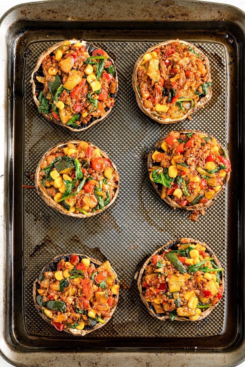 Stuffed vegan mushrooms on a baking sheet