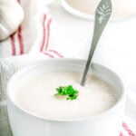 The best vegan mayo in a cup on a table with a spoon.