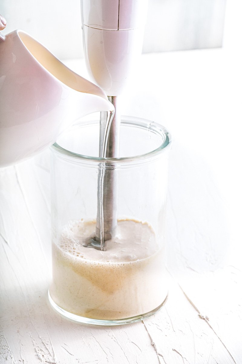 Dairy free mayo being blended with an emersion blender.