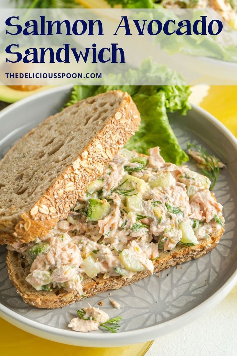 Pinterest pin showing a salmon salad sandwich on a plate.