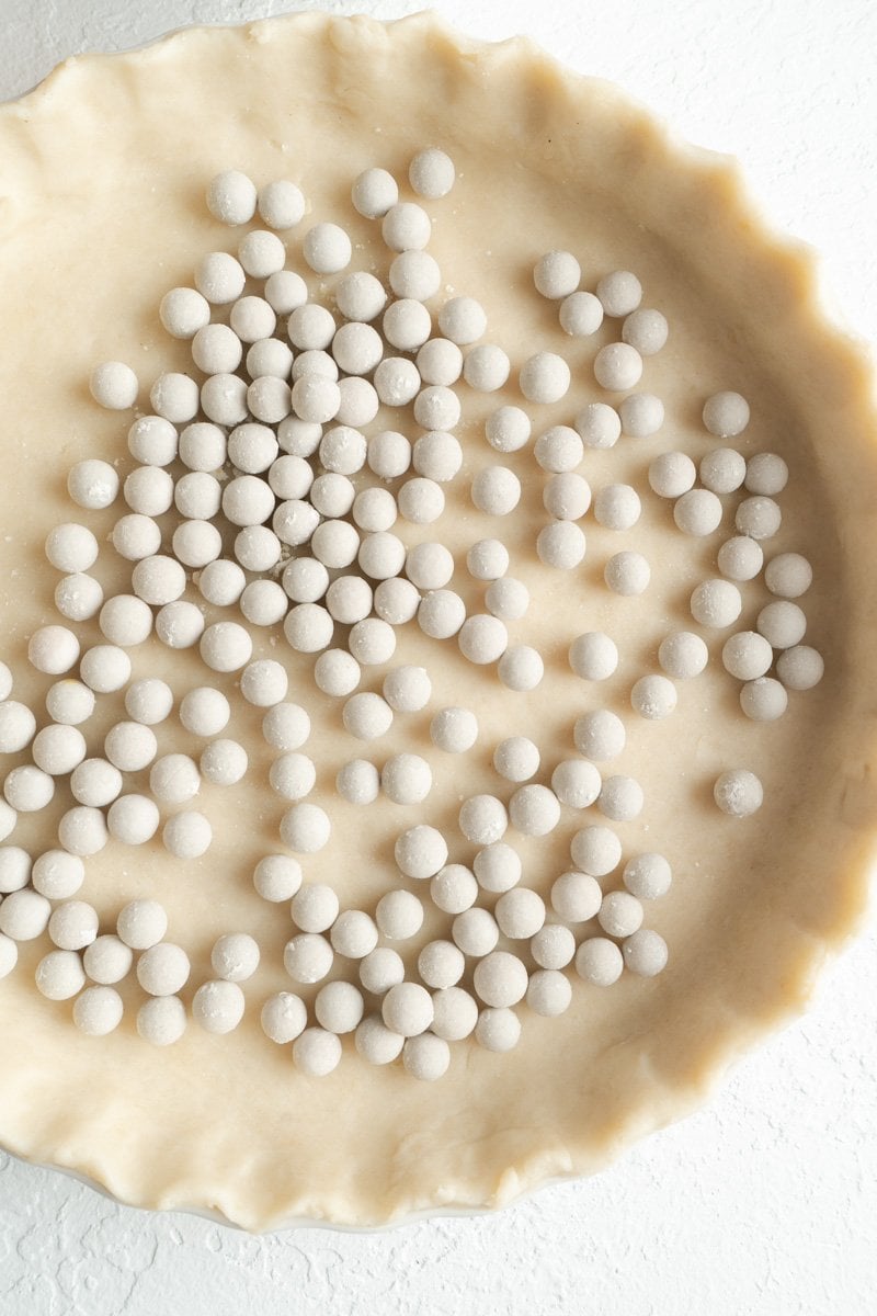 A pie plate filled with pastry beads.