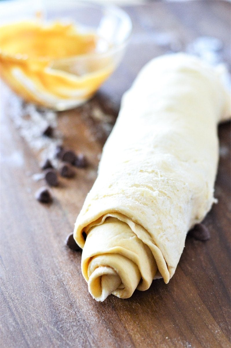 A rolls for a cruffin recipe on a cutting board.