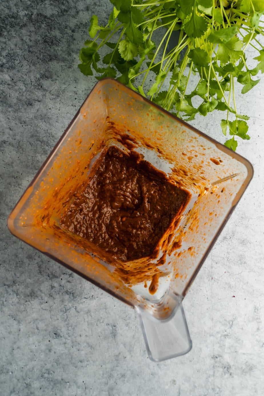 A blender filled with a chili in adobo spice mixture for beef birria.