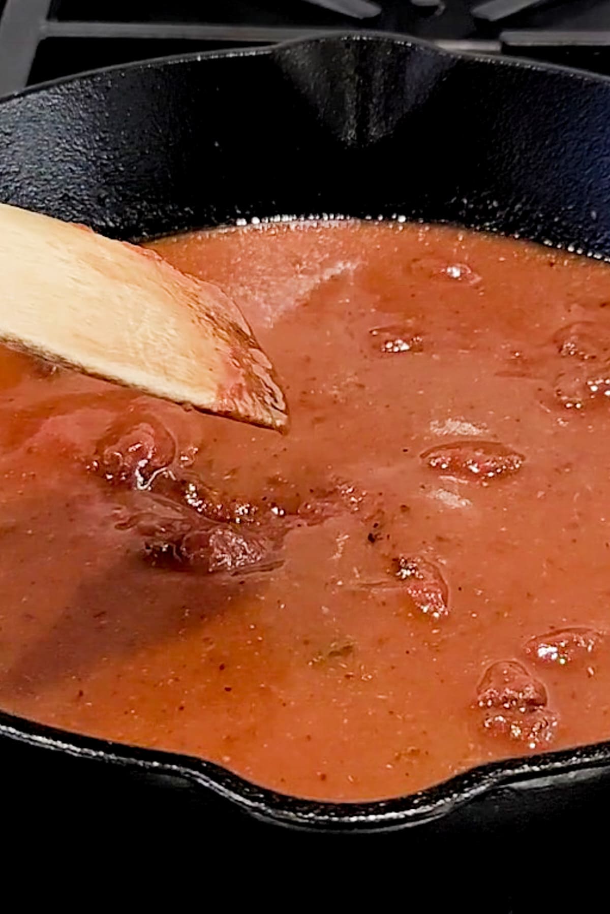 Cosomme for beef birria tocos being made in a pan.