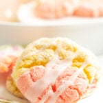 A strawberry lemon cookie on tea cup dish.