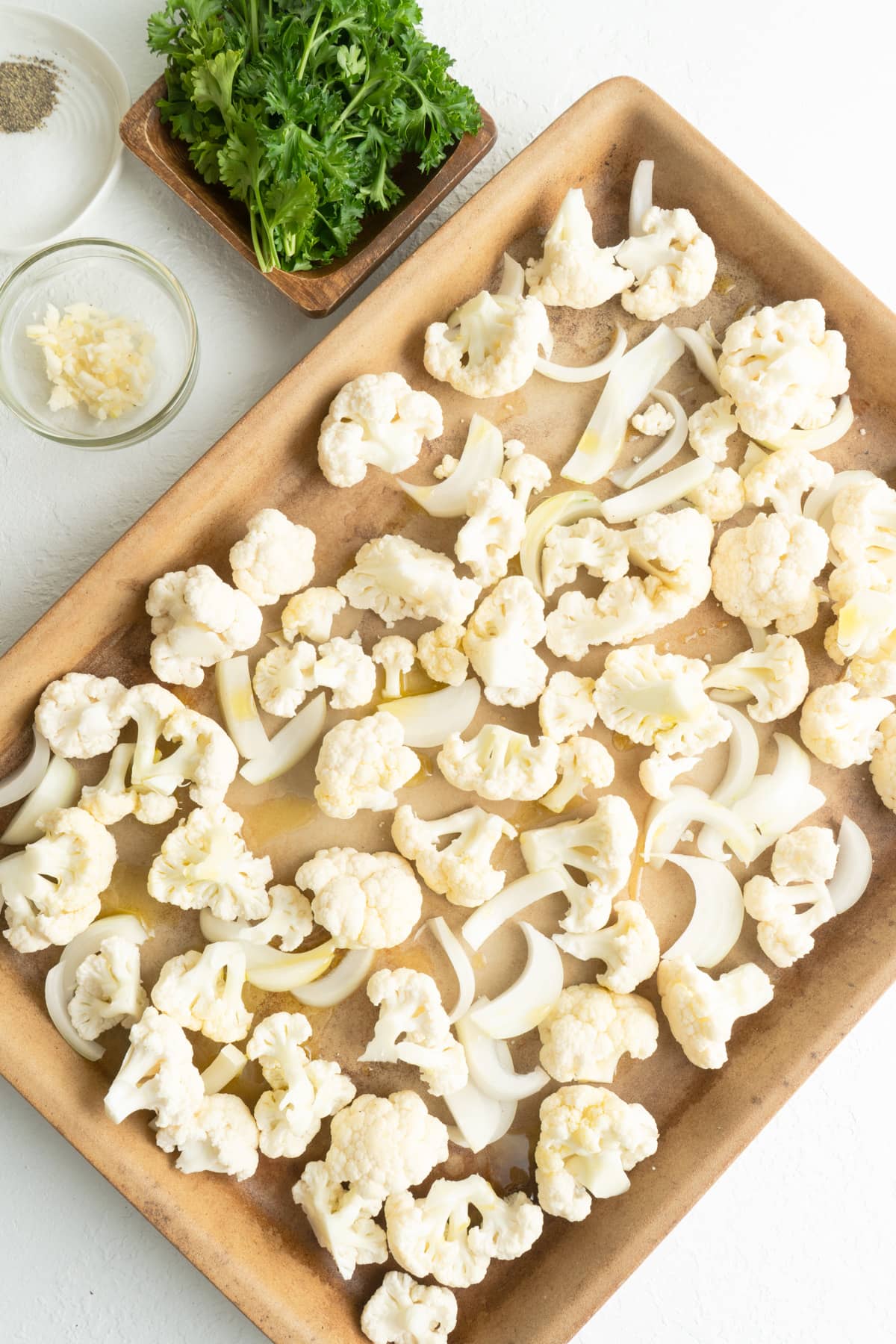 Cauliflower florets on a pan to be roasted.