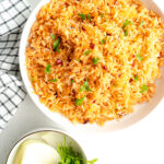 An adobo and rice recipe on a white table.