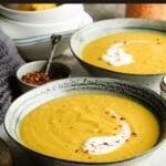 Pinterest pin showing two bowls or red lentil soup.