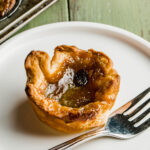 A Canadian Butter Tart on a white plate with a fork.