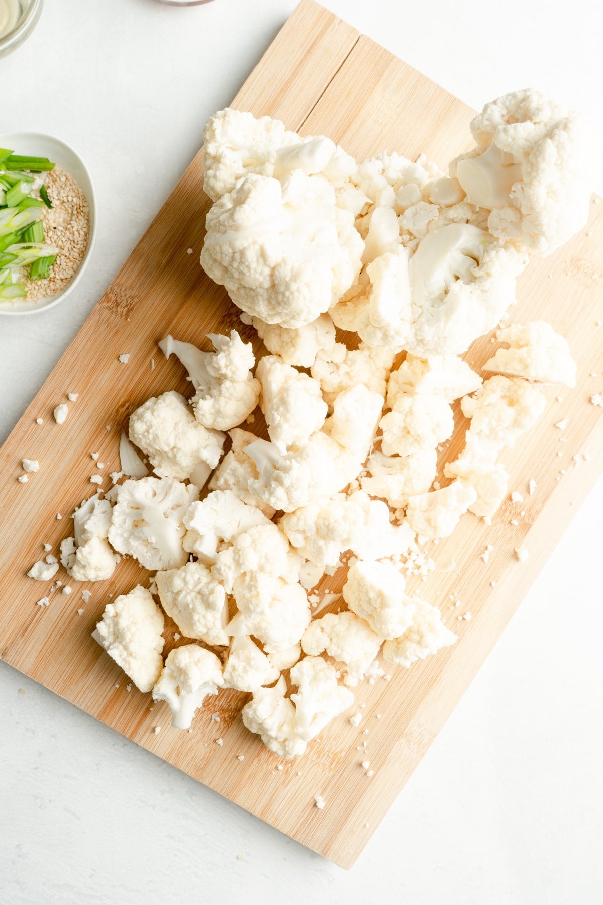Cauliflower florets on a board.