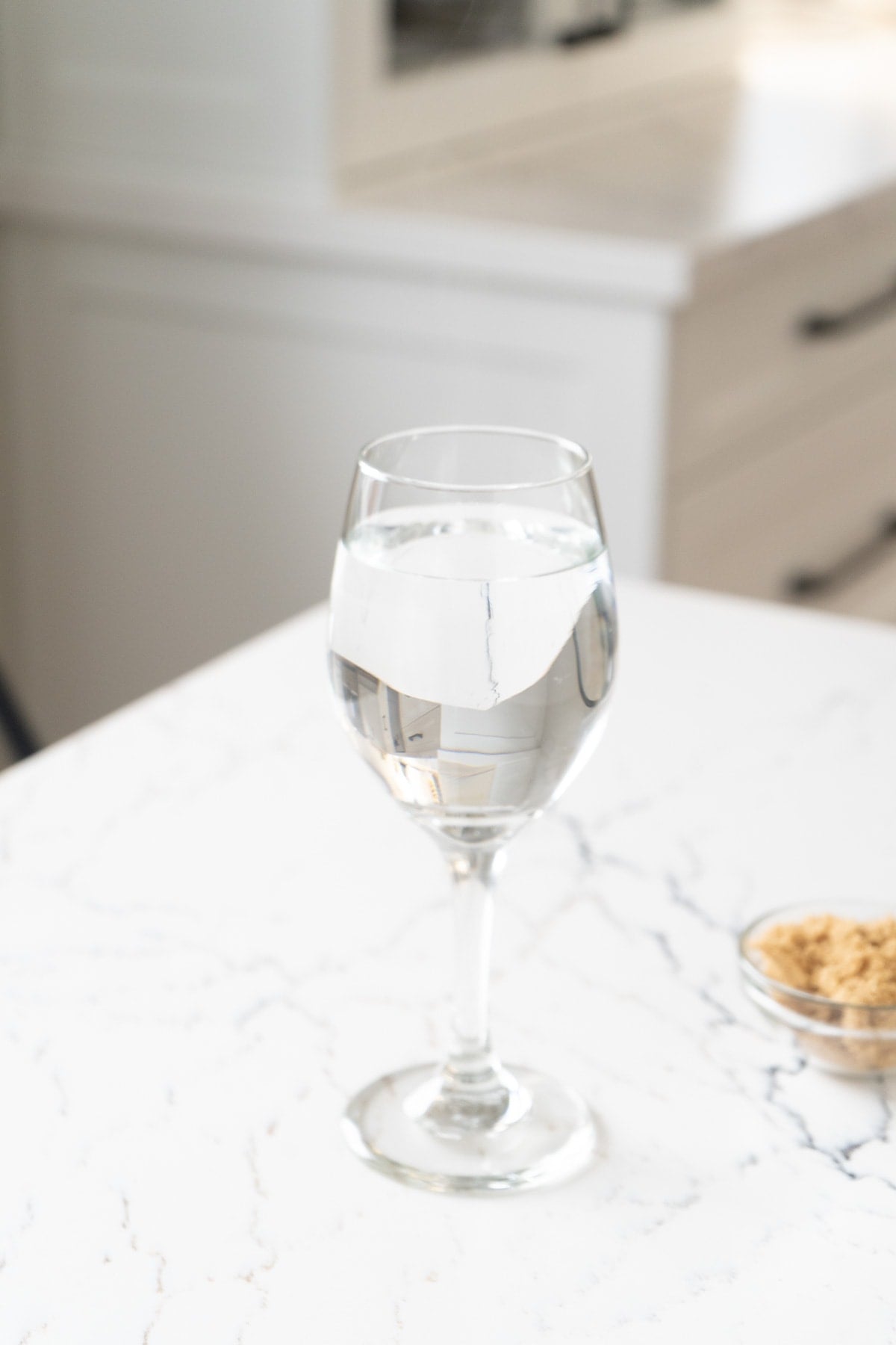 A wine glass filled with hot water.