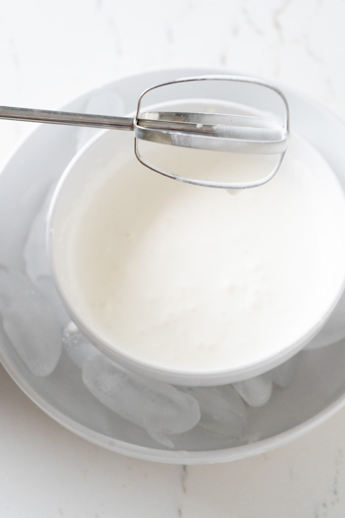 Whipping cream in a chilled bowl.