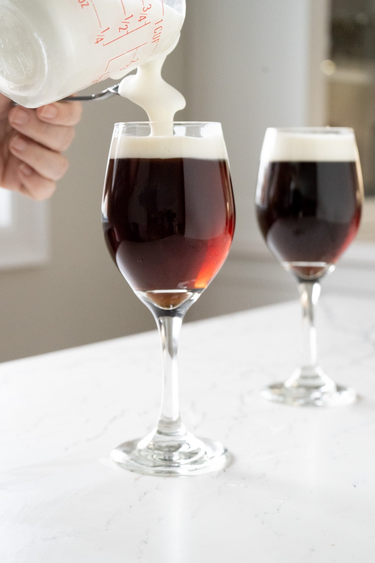 Adding frothed cream as a float for an Irish Coffee Recipe.
