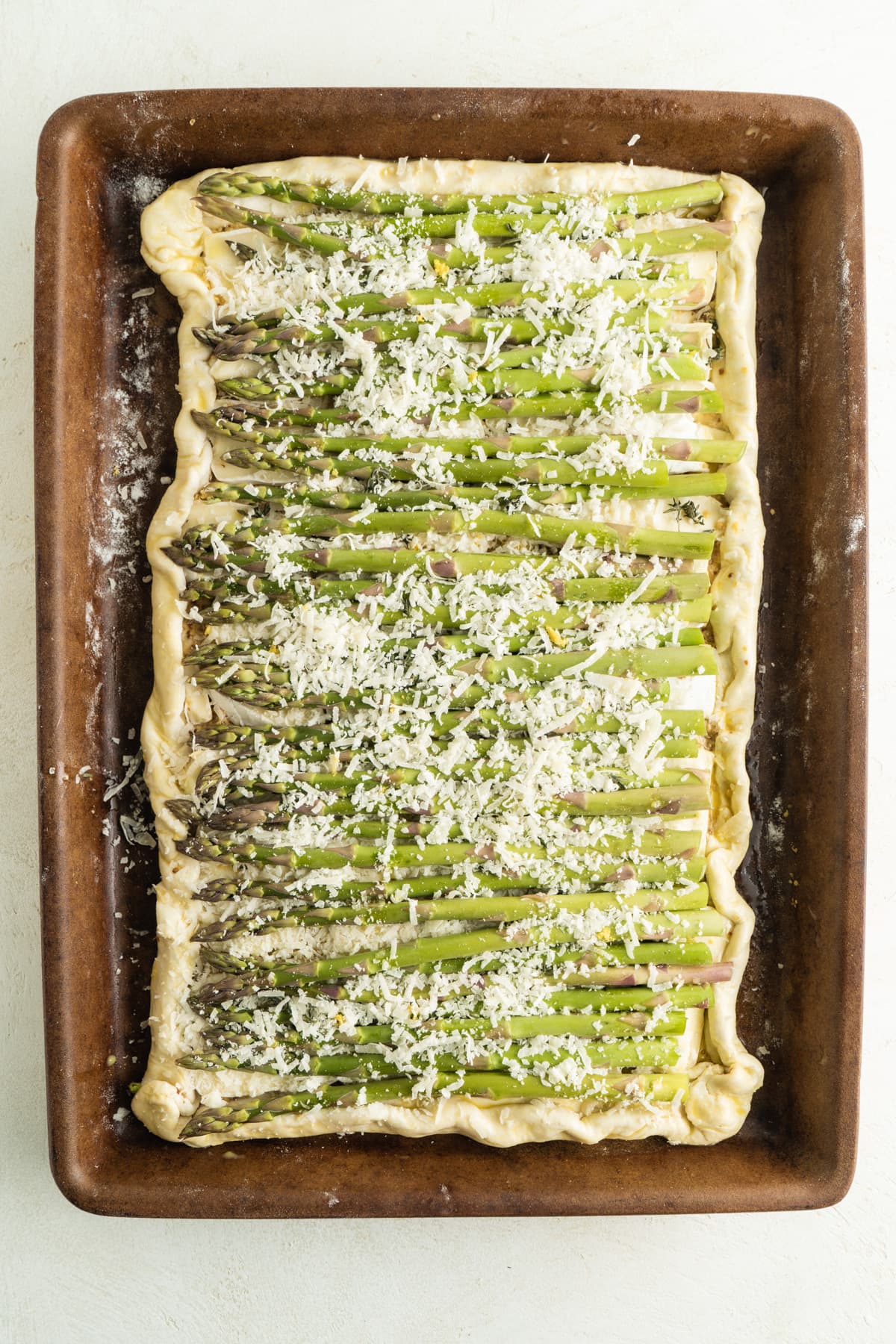 An unbaked asparagus puff pastry tart.