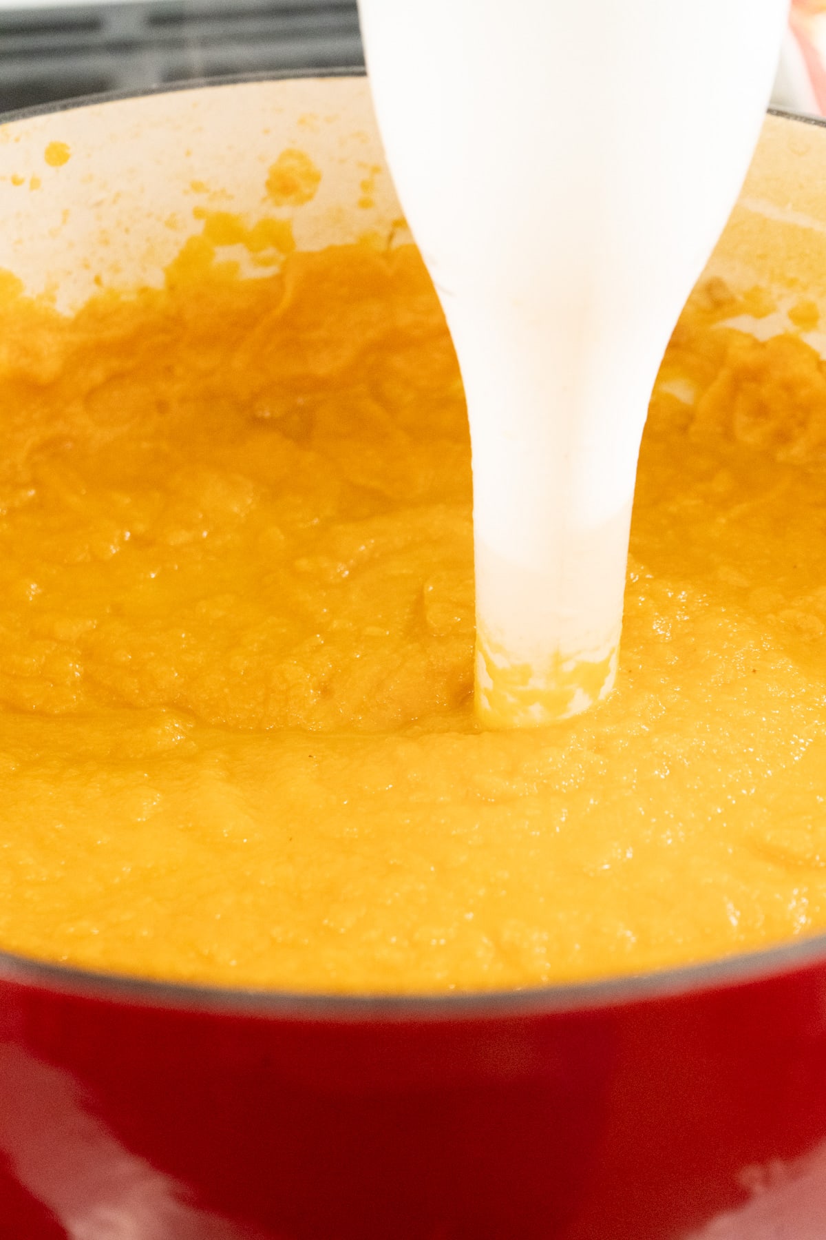 Carrot cauliflower soup being pureed.