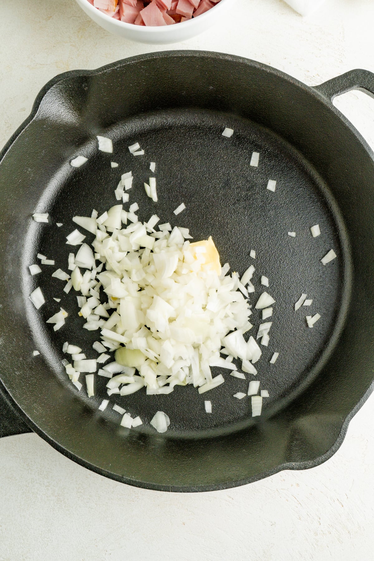 Onions and butter in a cast iron pan.