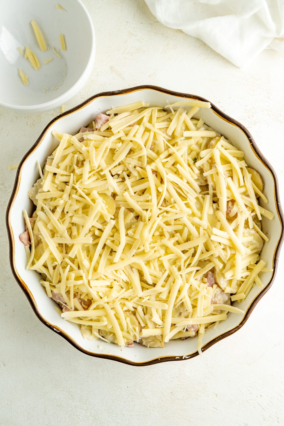 A casserole covered with shredded mozzarella.