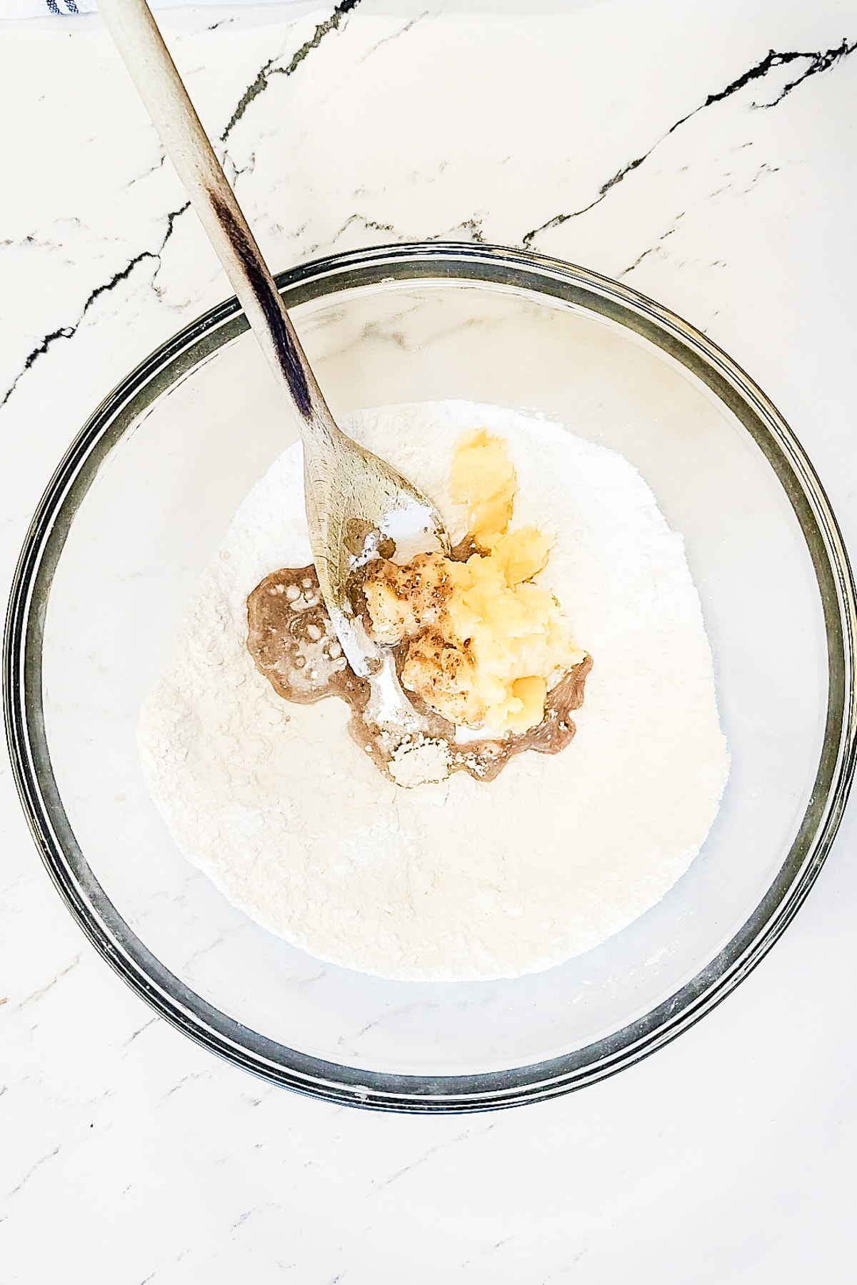 A bowl of flour, vanilla and vegan butter.