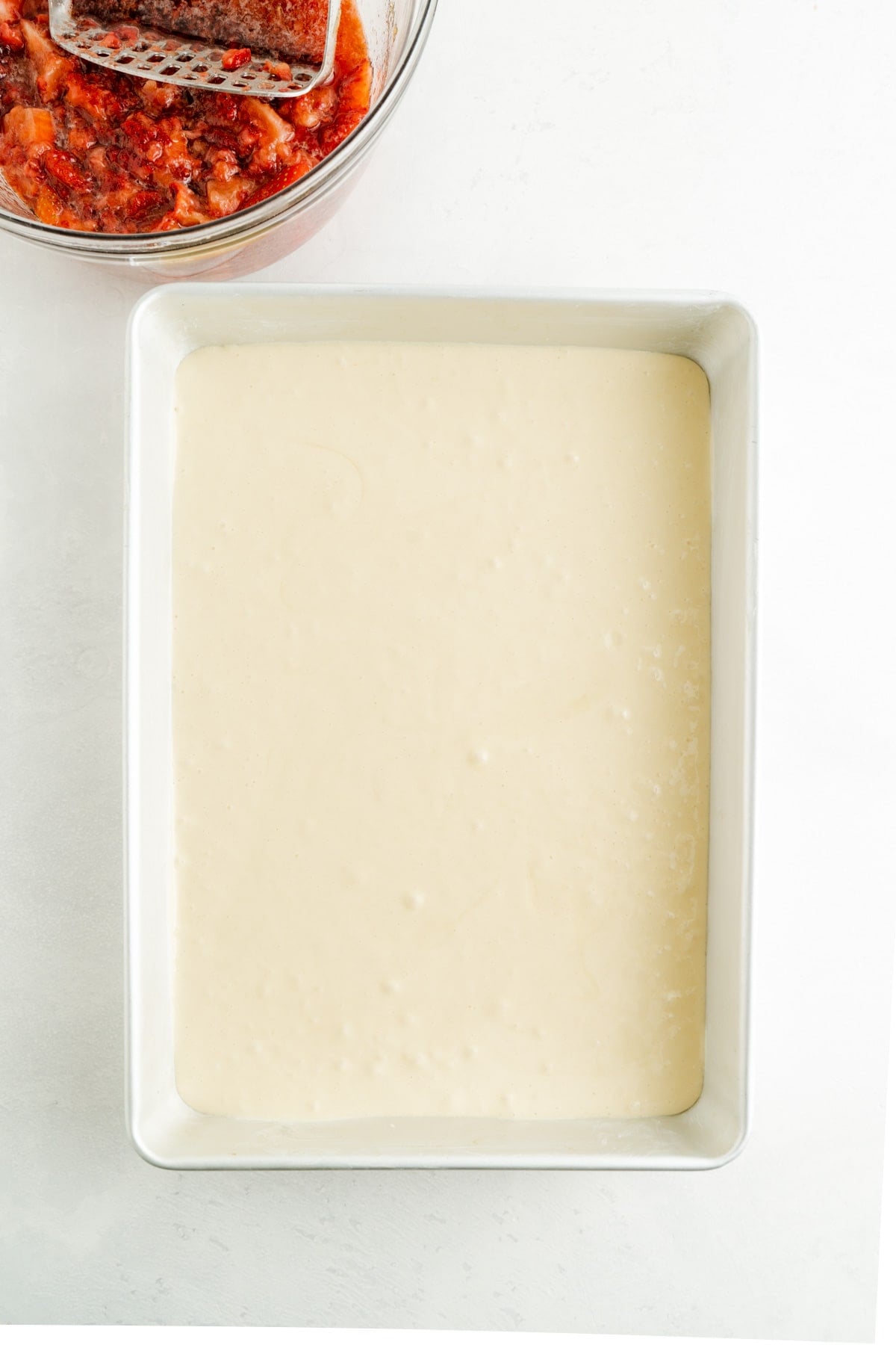 An unbaked vanilla sheet cake.