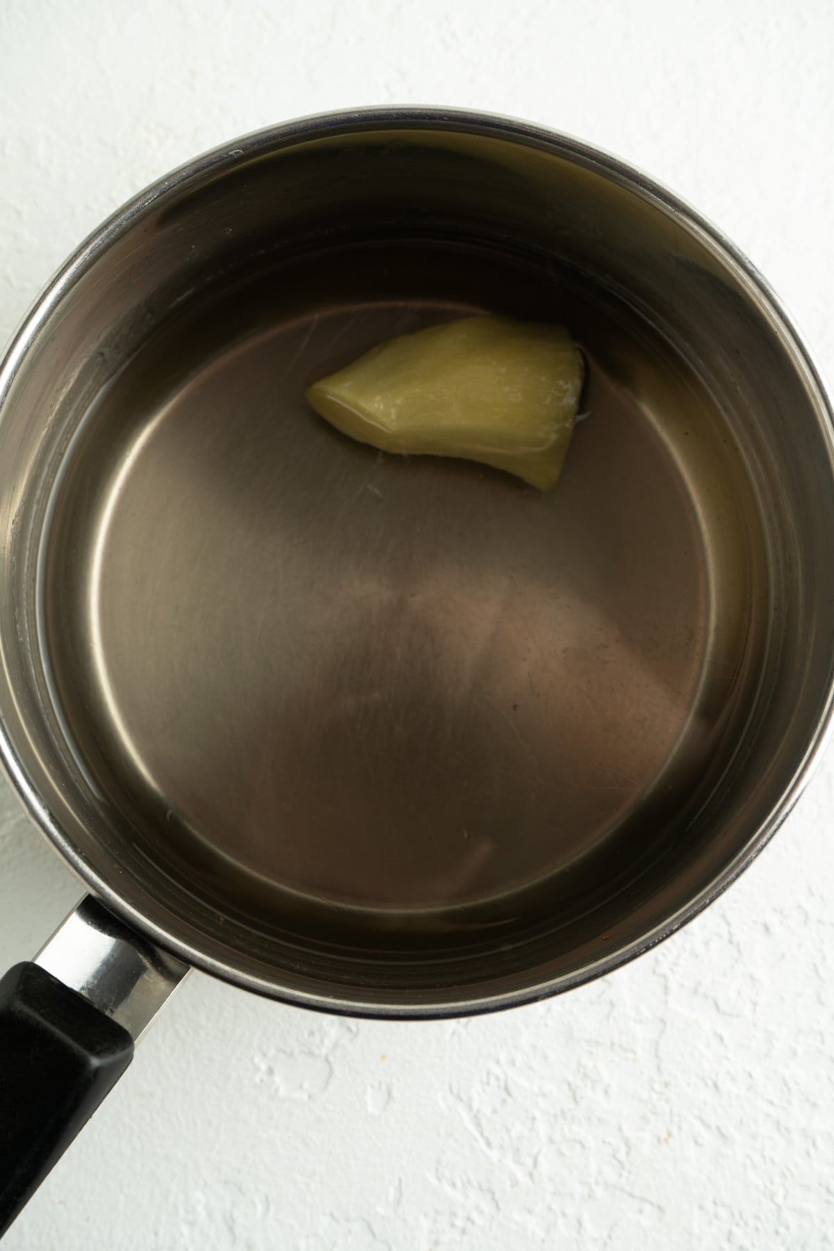 A pot of simple syrup with ginger.