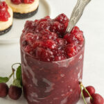 A glass jar of homemade cherry filling