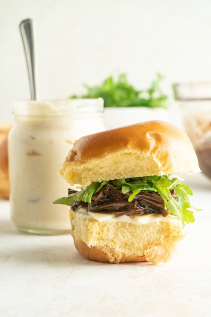 A roast beef slider on a white counter