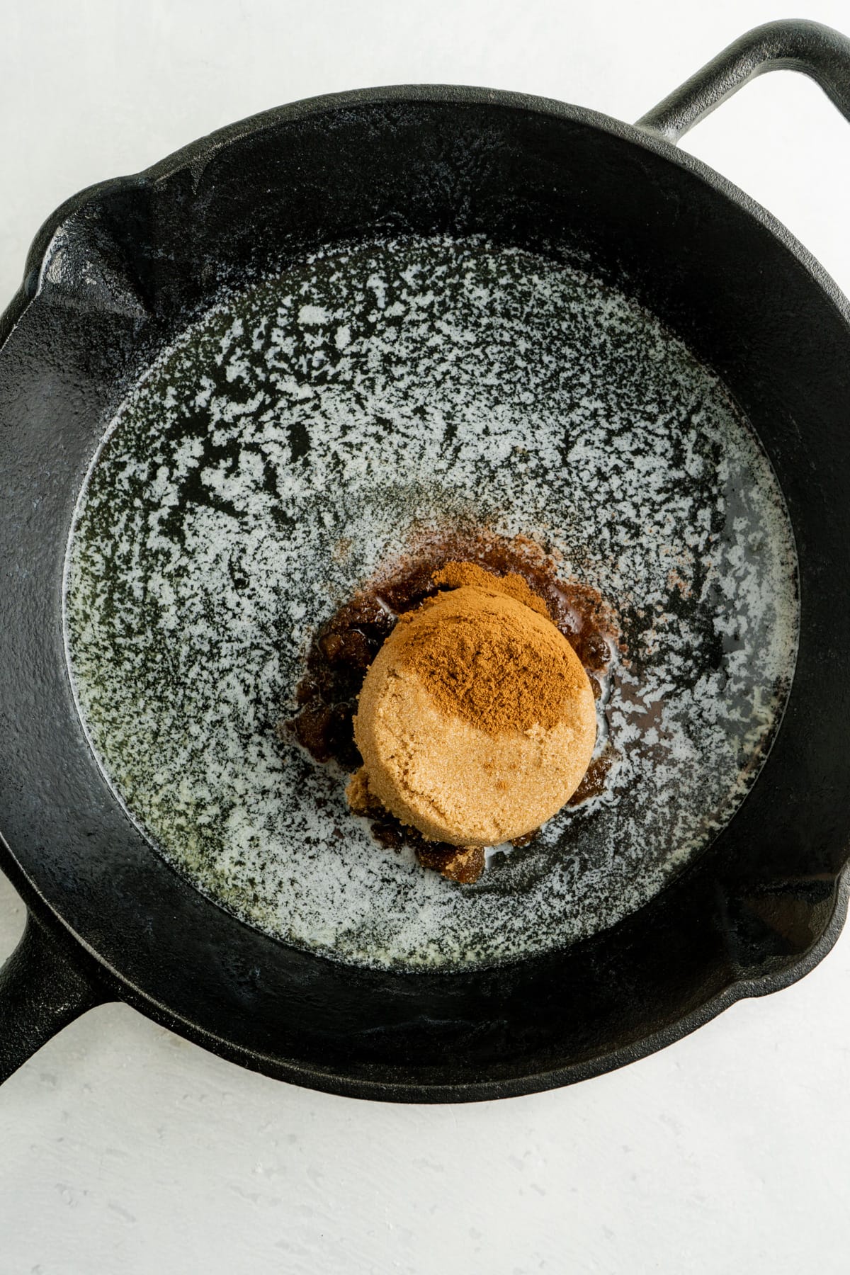 This Pear Upside Down Cake Recipe features a caramelized pear and brown sugar topping over a sweet, tender cake. Butter and brown sugar in a skillet