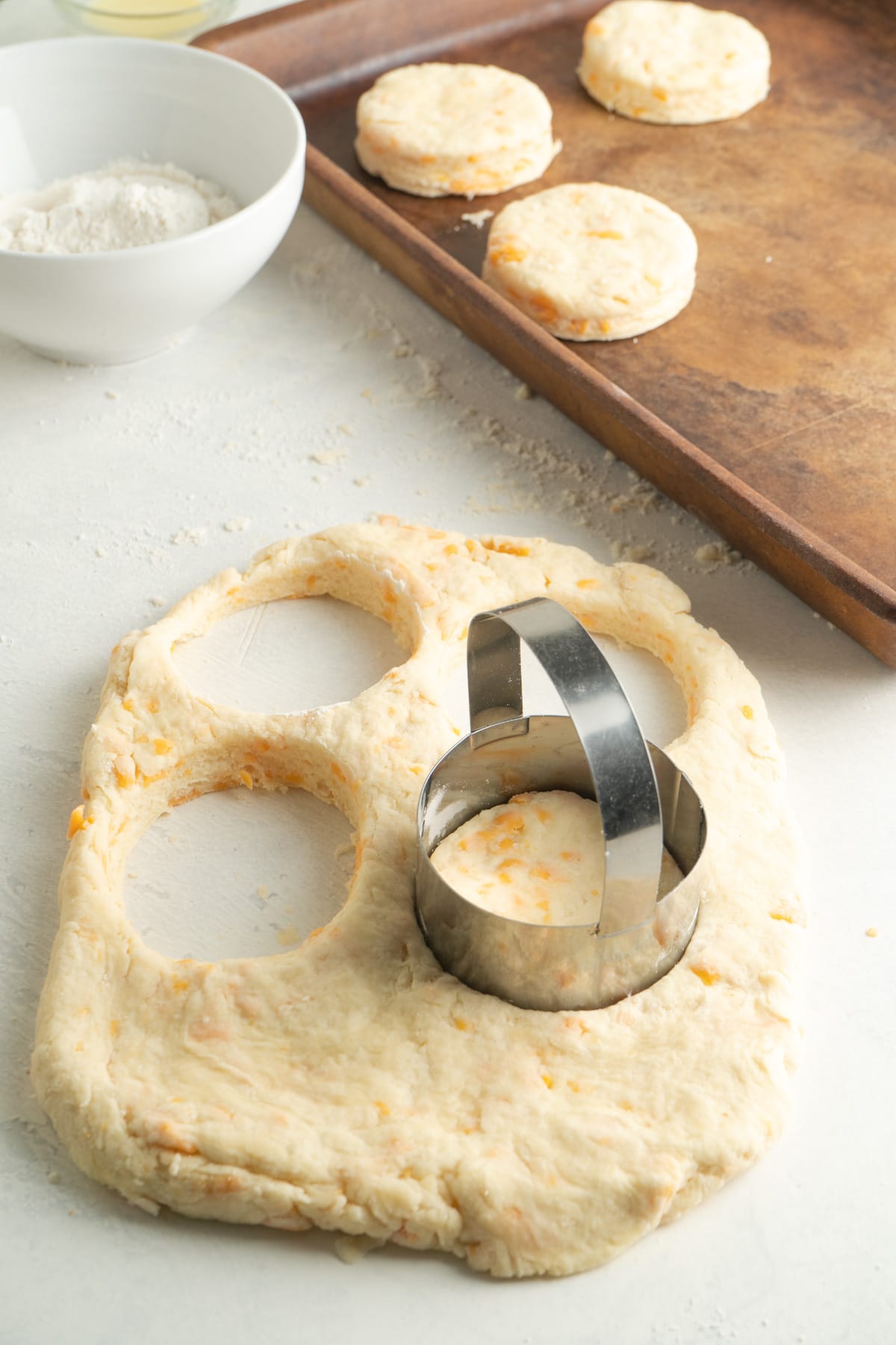 Cookie cutter cutting shapes in raw dough.