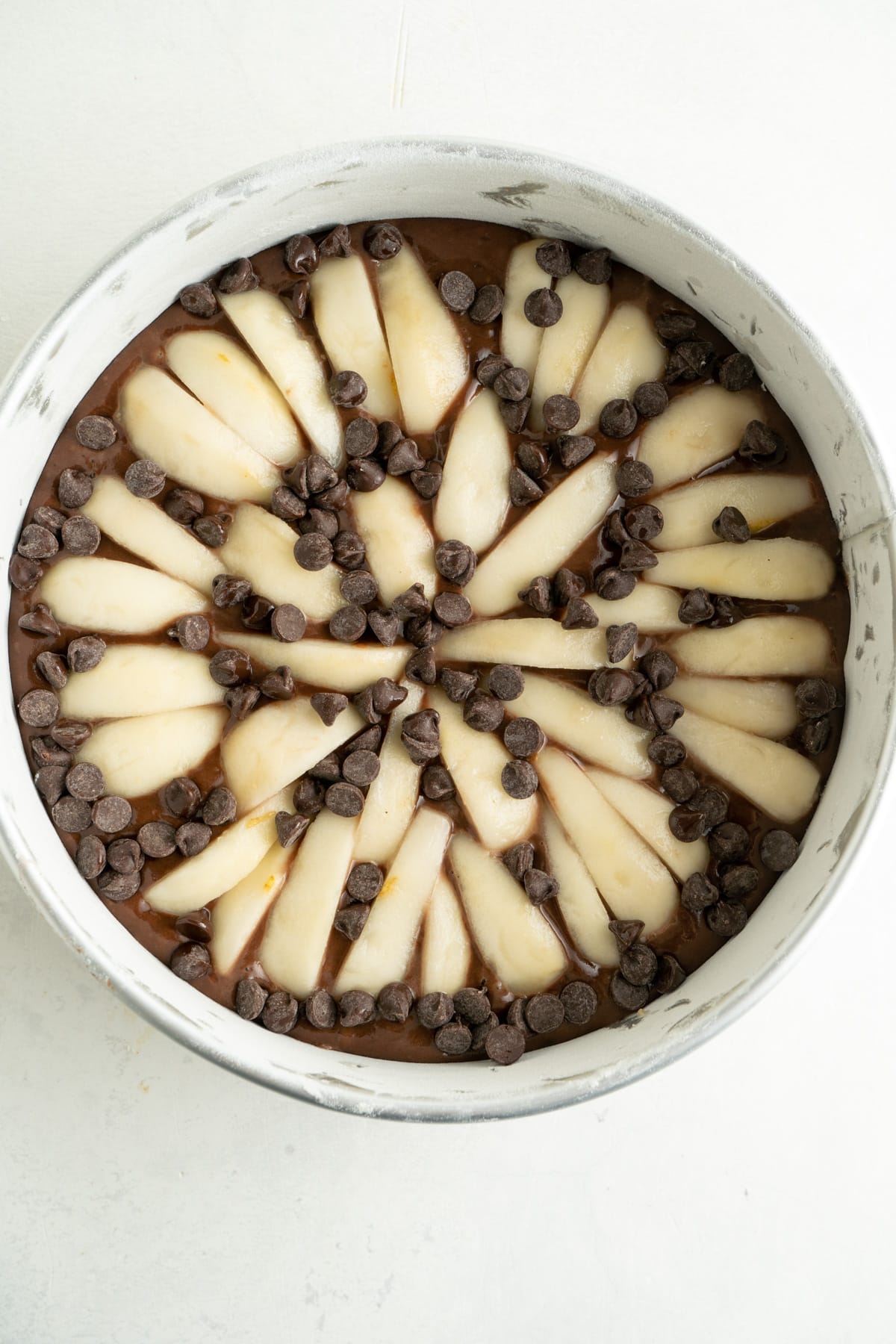 Pear slices on top of chocolate cake batter