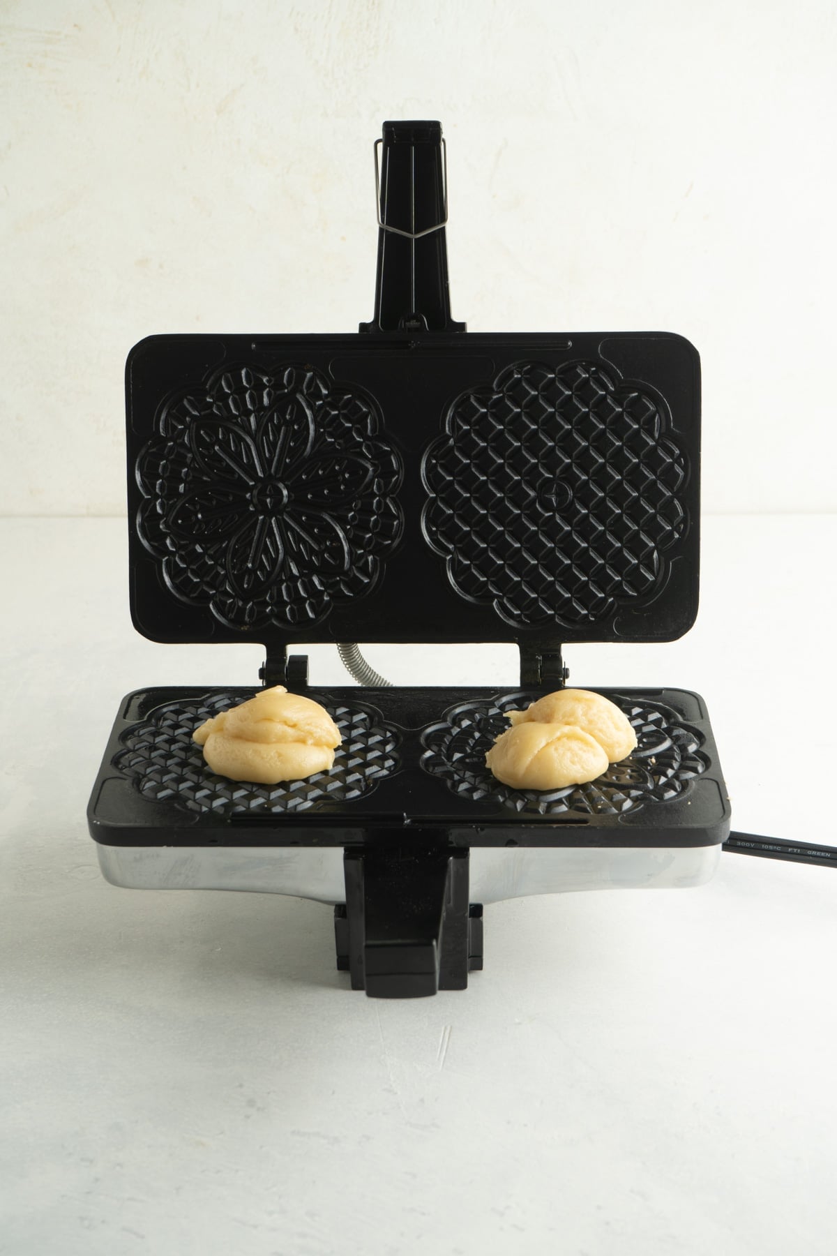 This Italian Pizzelle Cookie Recipe is made with just 7 ingredients. These classic cookies are thin, crispy, and sweet. A pizzelle press with batter