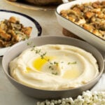 Creamy Parsnip Puree in a serving bowl, garnished with thyme.