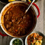 Overhead shot of a veal stew recipe on a table.