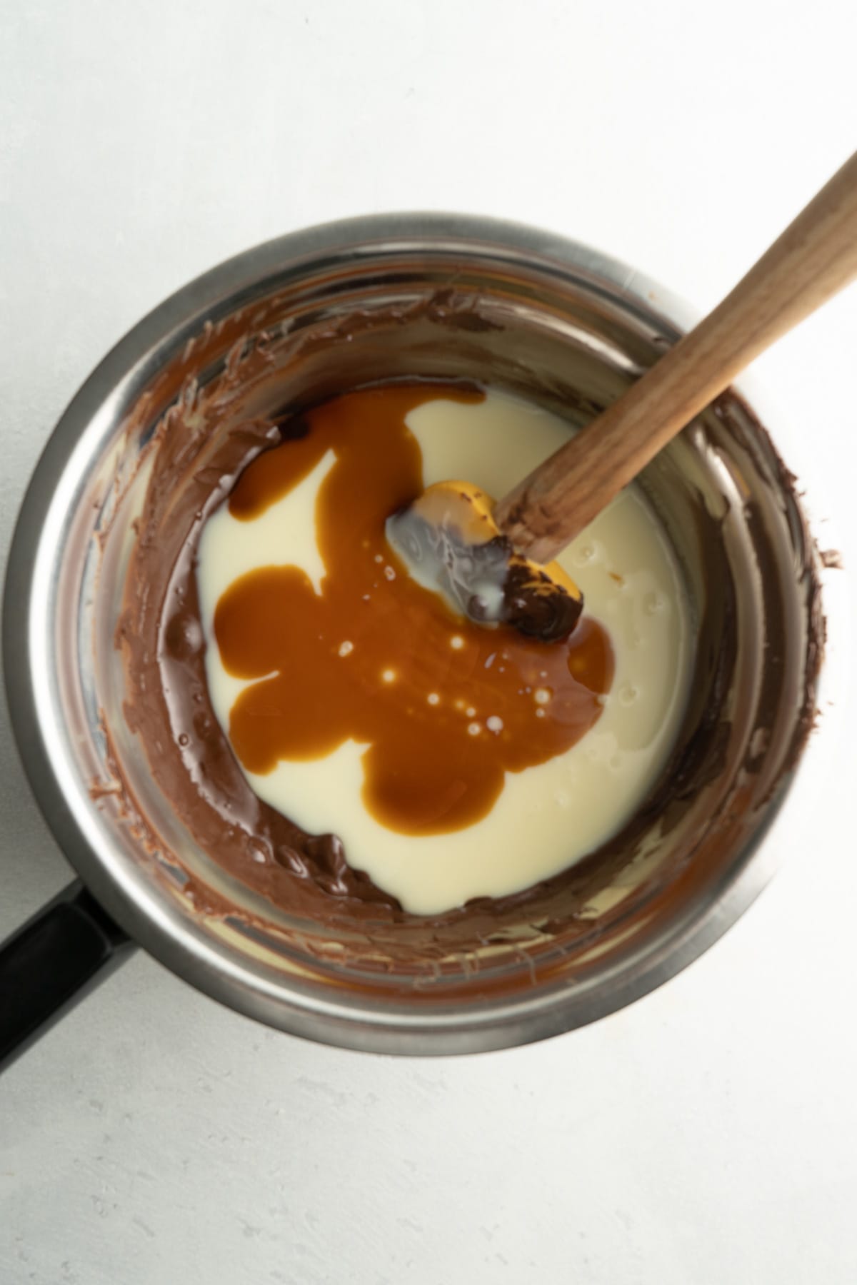Chocolate and condensed milk in a pot to make a condensed milk chocolate fudge recipe.