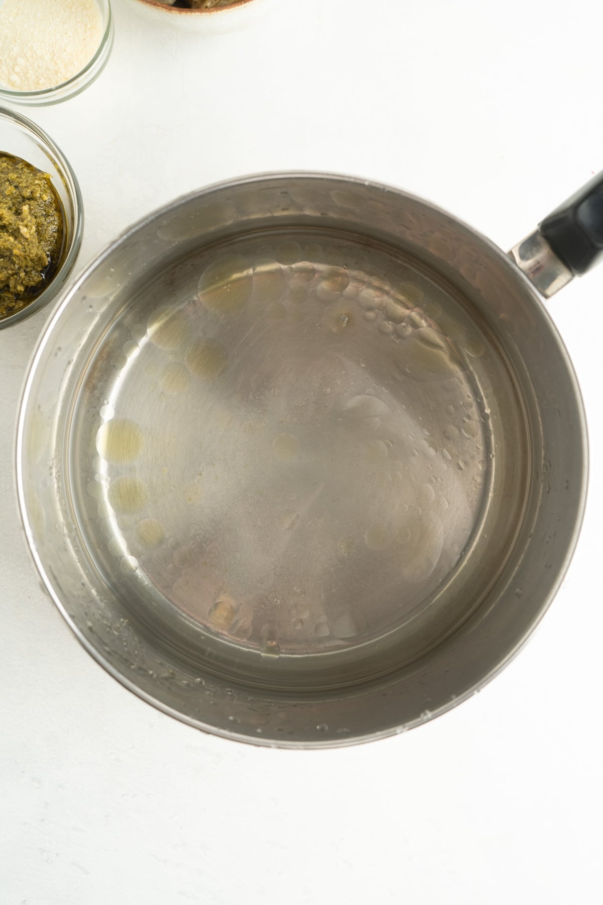 Olive oil and water in a pot.