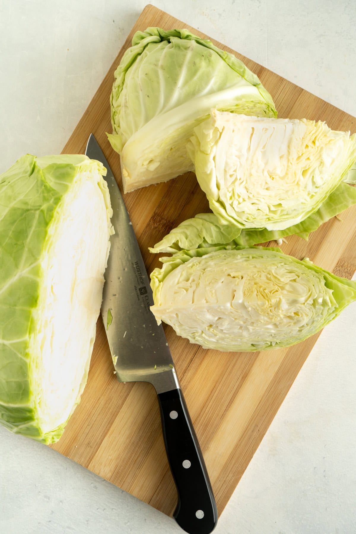 Cabbage being cut into wedges.