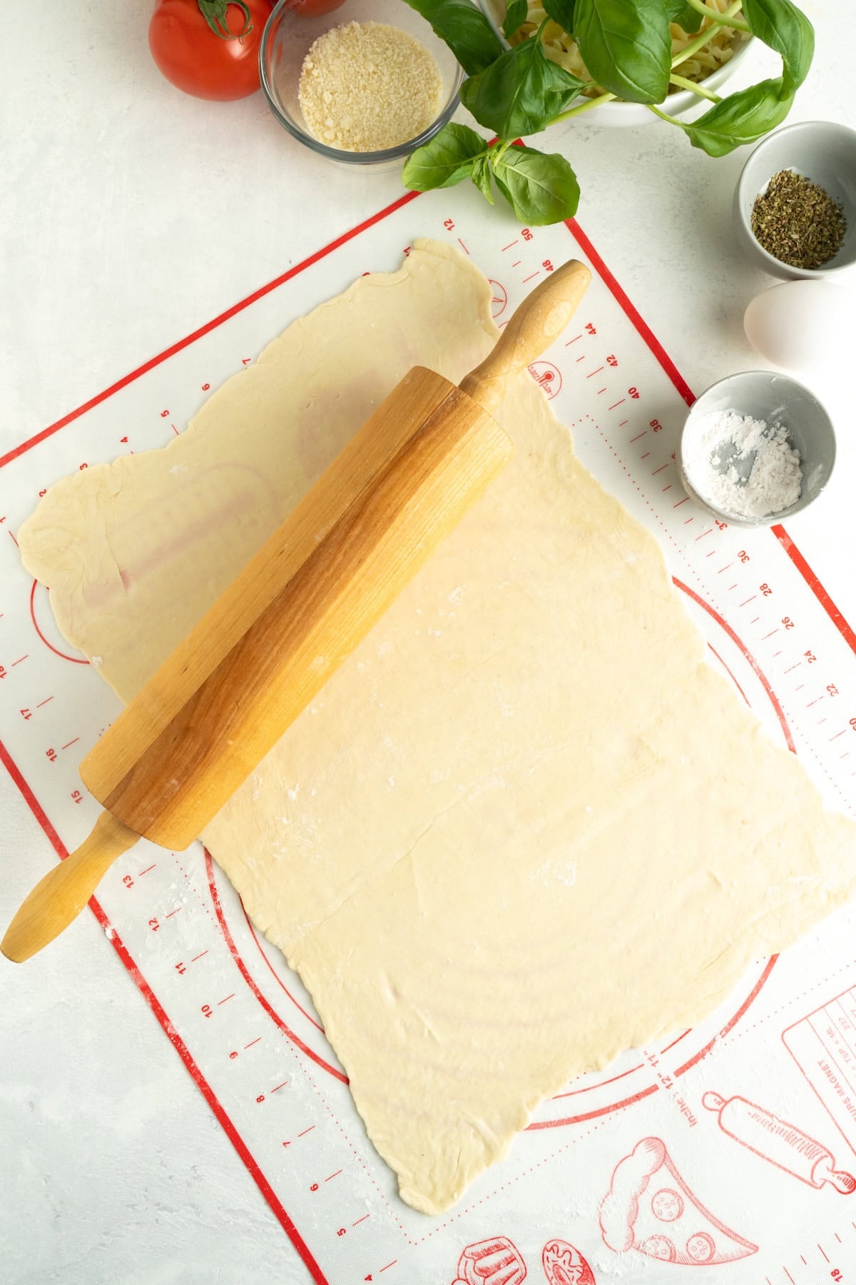 Puff pastry being rolled into a rectangle.