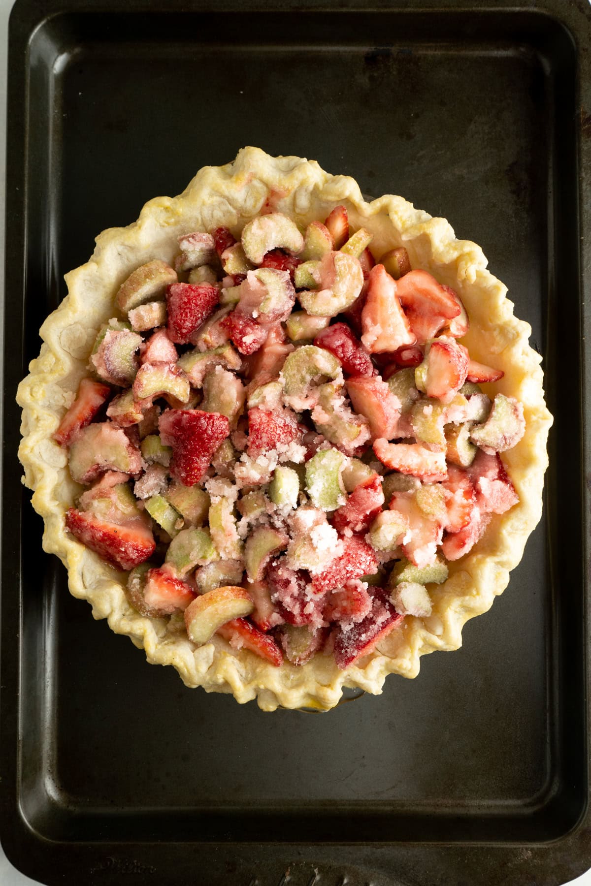 An easy strawberry rhubarb pie filled without a top.
