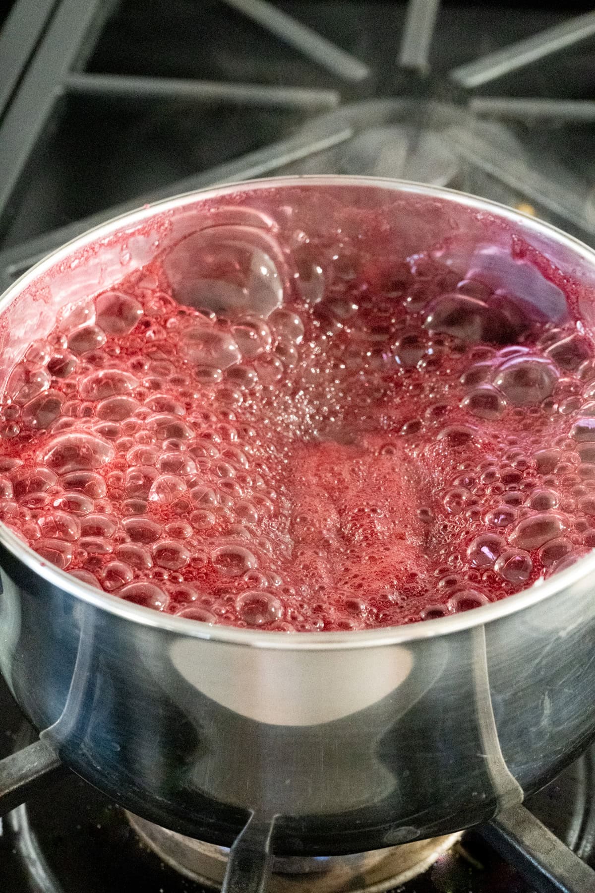 Blackberries being boiled in a pot for an easy blackberry jam.
