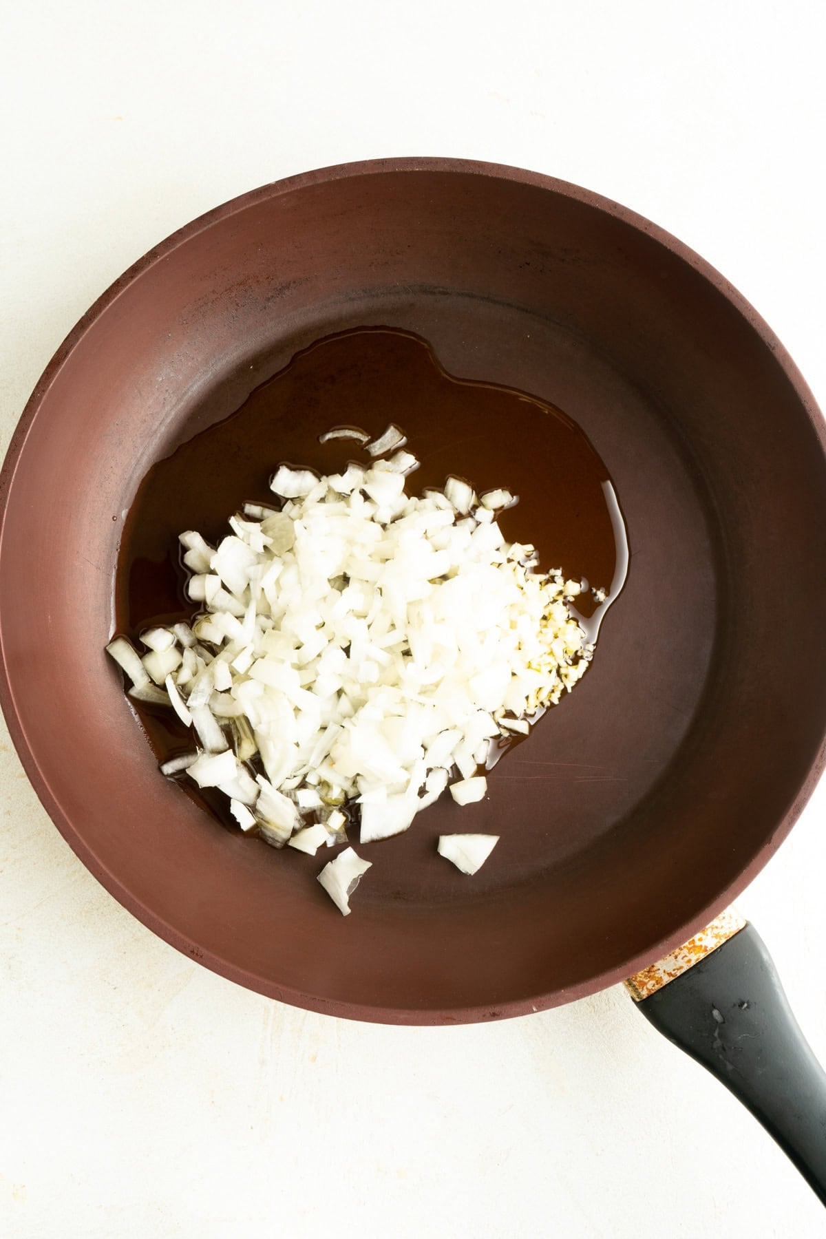 Chopped onions in a pan with olive oil.