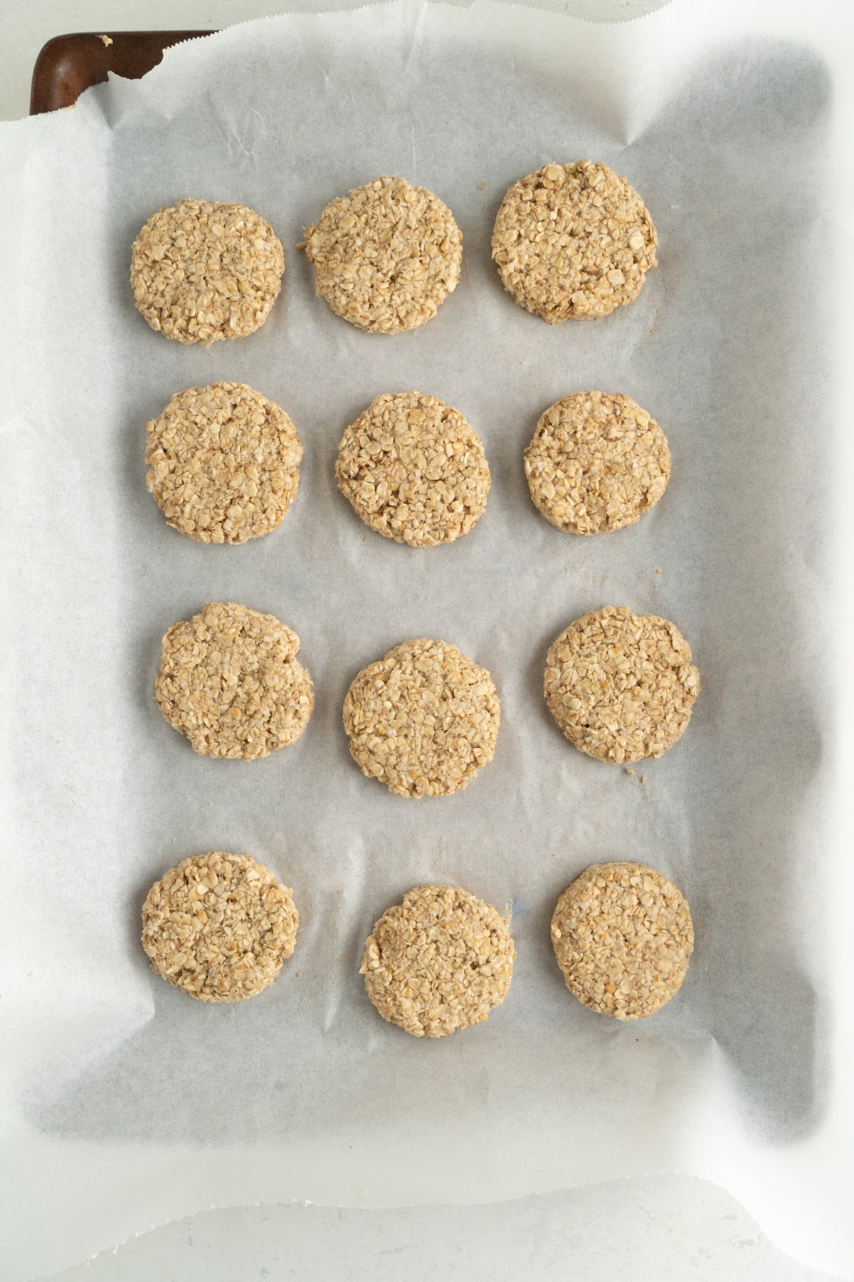 Oat cookies made with applesauce on a baking sheet.