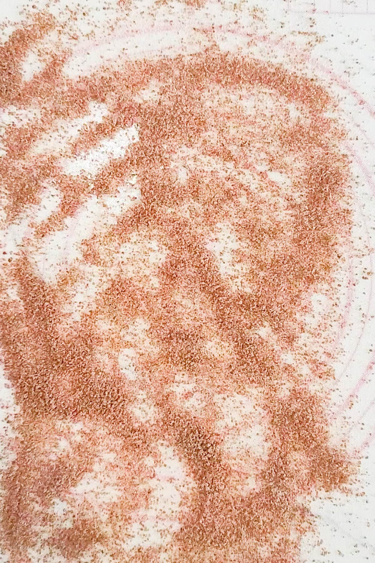 Sugar and spice on a flat surface.