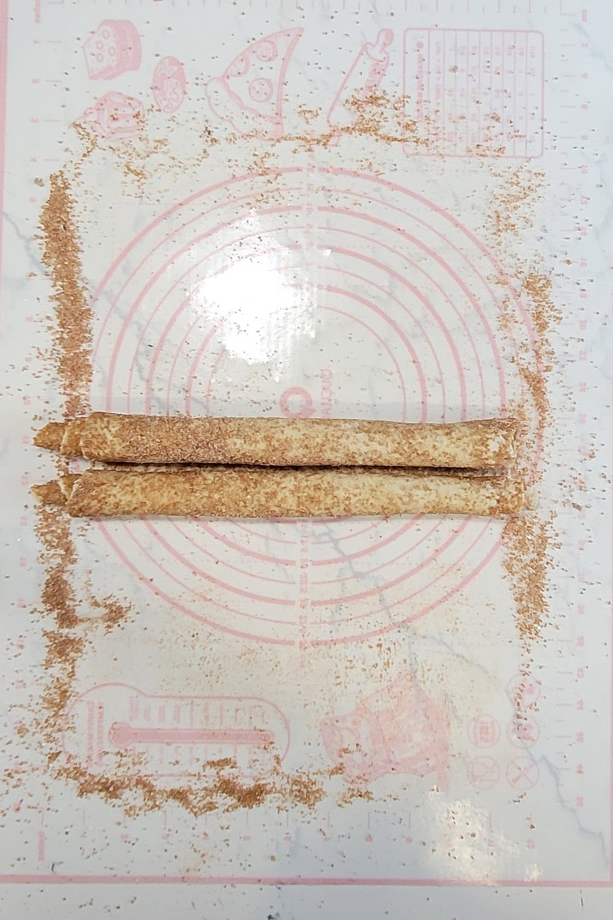 A recipe for palmiers being rolled before cutting.
