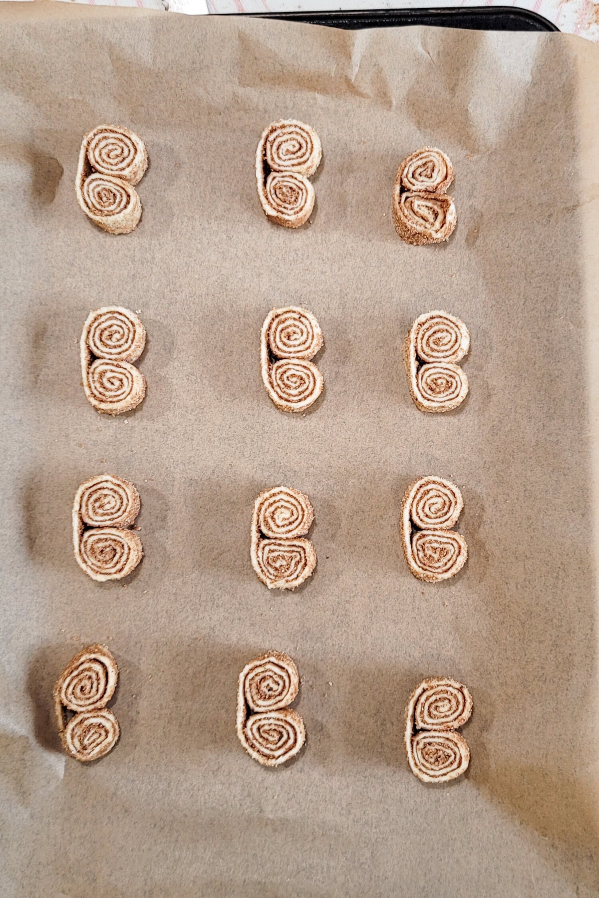 Unbaked puff pastry cookies on a cookie platter.