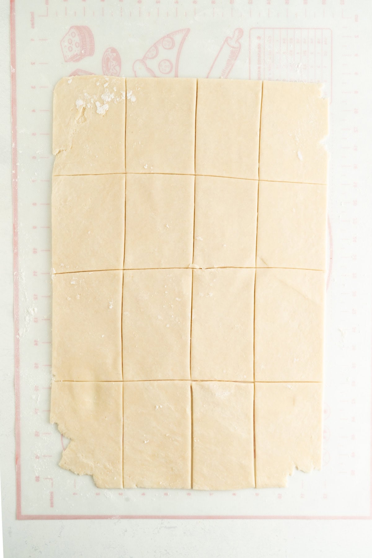 Pastry cut into rectangles on a table for a hand pie recipe.