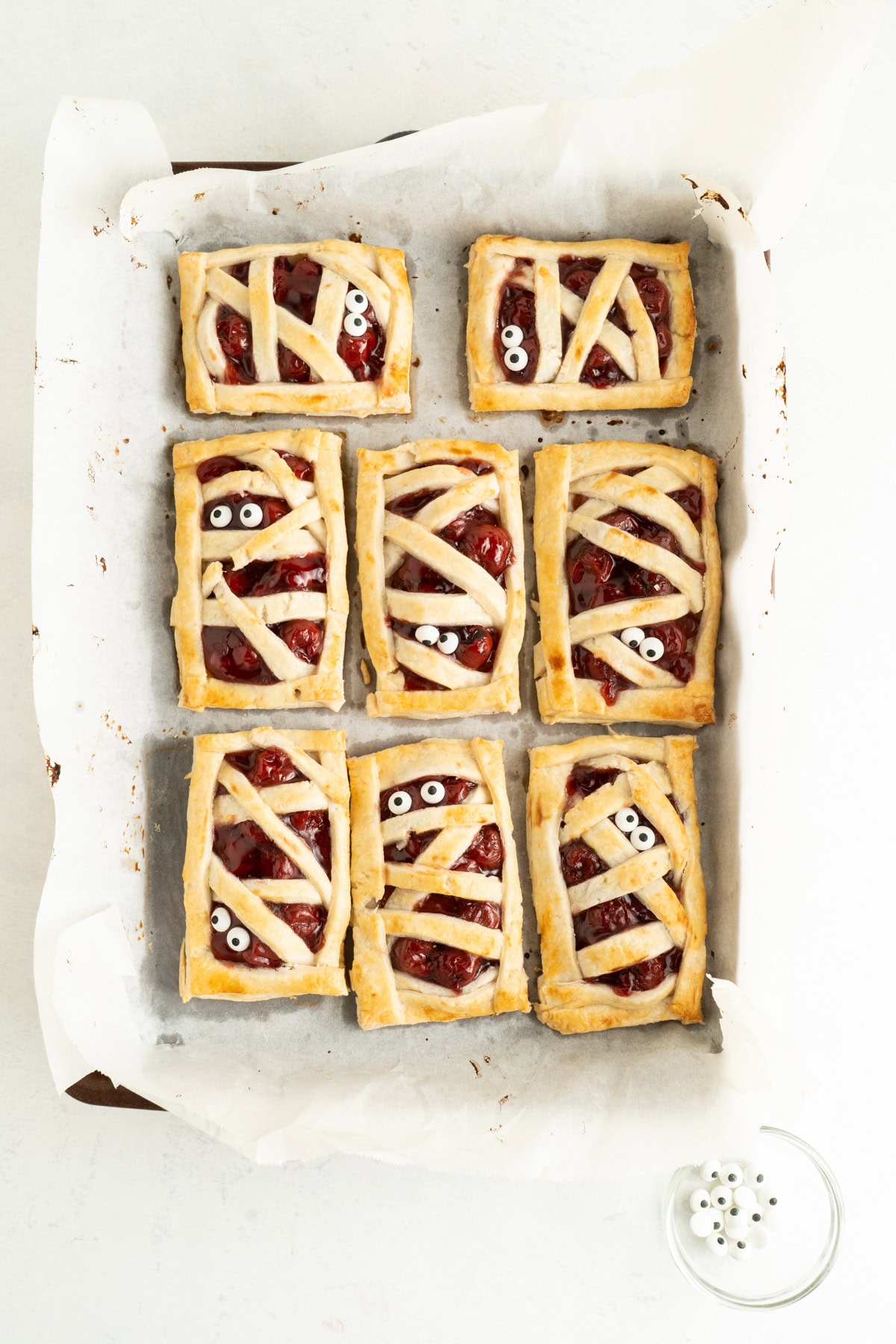 A hand pie recipe made with cherry pie filling on a baking sheet.