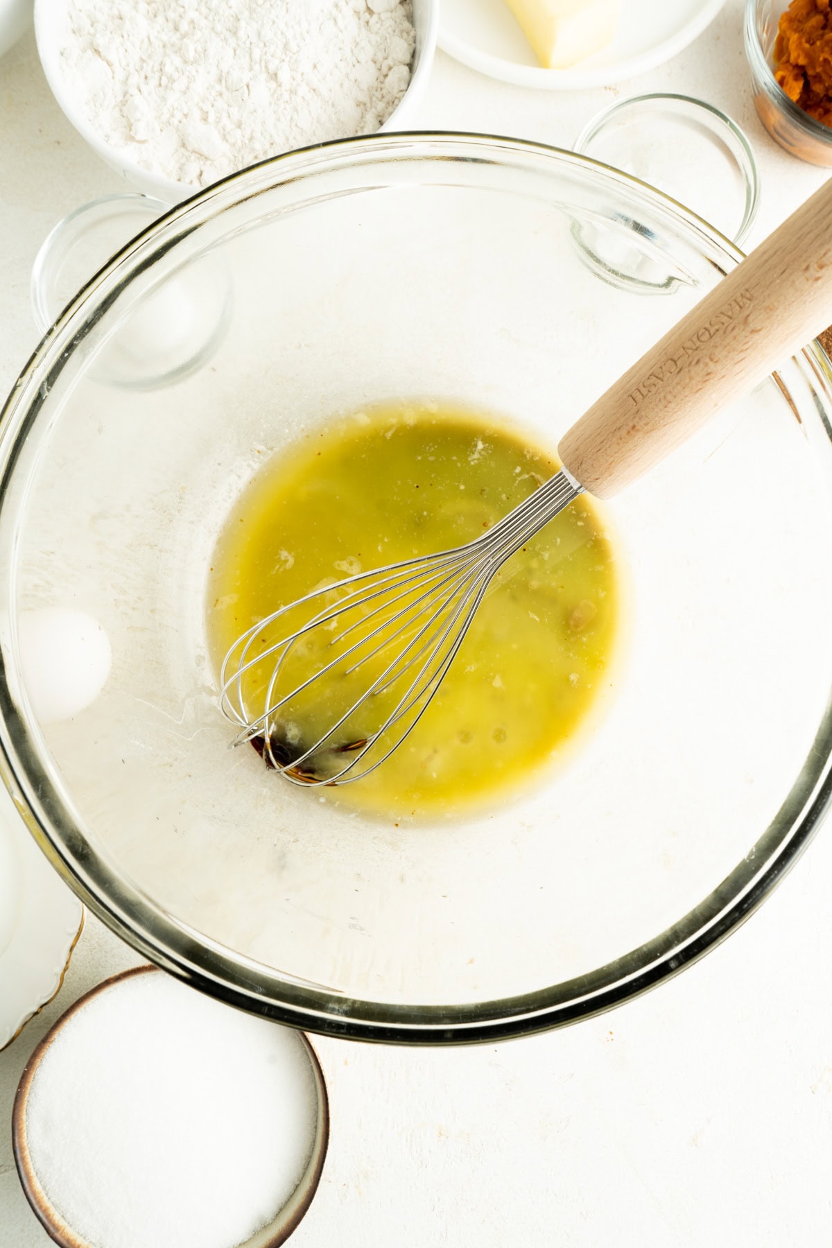 Egg, butter and sugar being whisked.